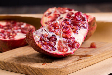 juicy pomegranate on a wooden board