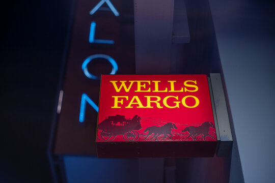 LOS ANGELES -February 28, 2024: Wells Fargo bank logo sign on bank office outdoor at night.