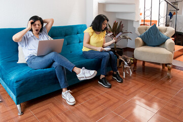 Two Sisters Spend Time Together In Their Living Room With Their Pet