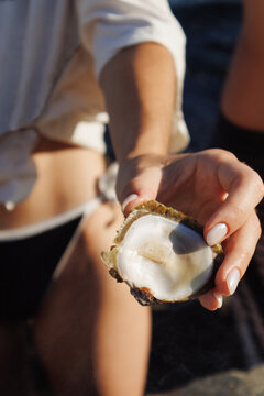 Hand with oyster shell