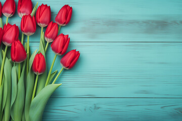 Fresh spring red tulips flowers on turquoise painted wooden planks. Selective focus. Place for text