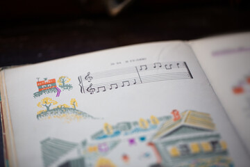 A page from a book with musical notes as a background, close-up view