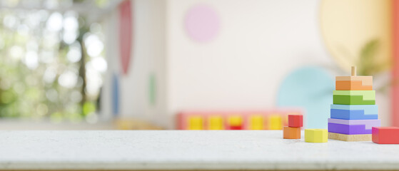 A presentation space on a table features colorful kid's toys in a kid's playroom or nursery.
