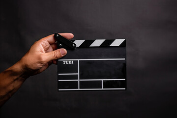 Hand Holding a Clapperboard Ready for Cinematic Action Banner