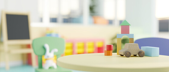 A close-up image of a green round table features kids' toys in a colorful kindergarten classroom.