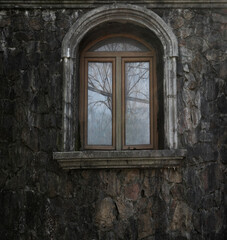 grey stone exterior.  building wall with one arched window. large arch window frame in a brick stoned wall background.