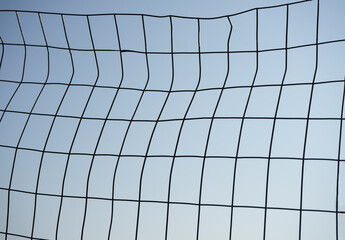 steel square grid isolated on blue sky background. Grid on a white background. Grid. Iron netting....