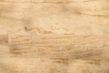 Decorative square beige tile on the facade of the building as a background or backdrop. Rectangular cut out blue marble wall texture background can be, tiled with seams lined up