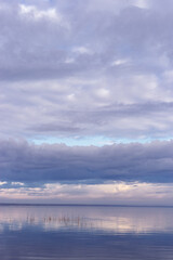 Beautiful white blue clouds over lake, symmetric sky background, cloudscape on lake Ik, Russia....