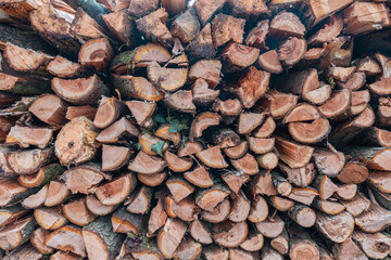 Pile of chopped firewood prepared for winter. Natural background.
