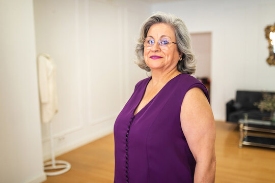 mature bridesmaid at dress fitting in bridal store