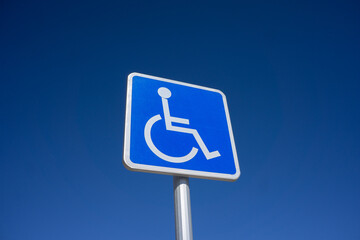 Blue Handicapped Parking Sign with Blue Sky Background - 751274538
