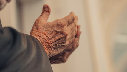 Hands of elderly Muslim man praying in mosque. Ramadan month.