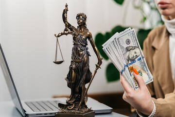 A young woman lawyer at the workplace counts money. Concept of corruption, bankruptcy court, bail,...