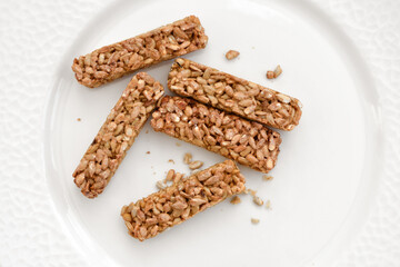 Plate with tasty pieces of kozinaki and sunflower seeds. Top view