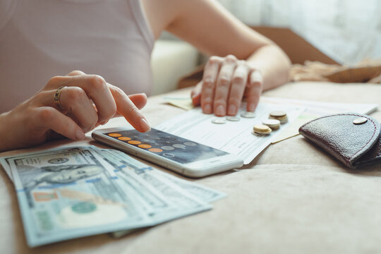 Close up of woman hands busy paying rental tenancy bills online 
