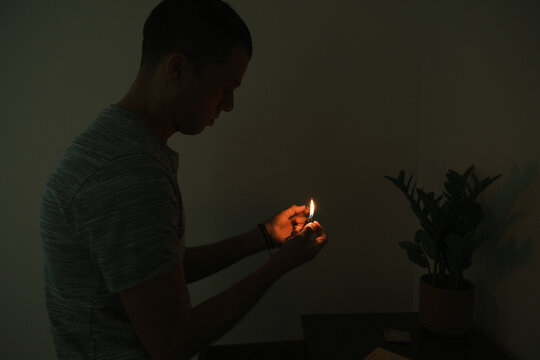 Flame Lighting Incense in Dark Room