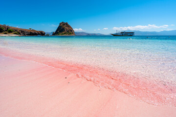 Tropical pink sandy beach with clear turquoise water at Komodo islands in Indonesia