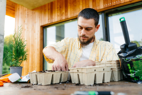 A man plants seedlings outdoors