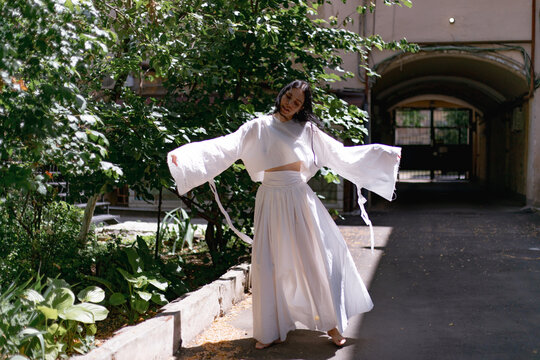 woman dancing in a white dress