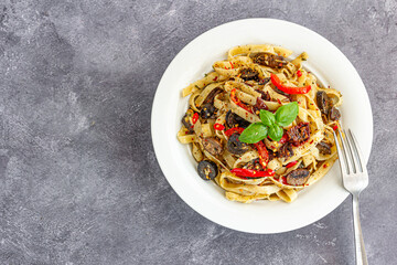 Fettuccine Aglio e Olio Pasta Garnished with Fresh Basil Leaves in a Bowl Top Down Italian Food Photography