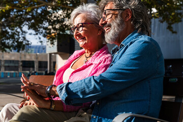 Fototapeta premium Beautiful happy senior couple bonding outdoors - Cheerful old people romantic dating in the city, concepts about elderly and lifestyle