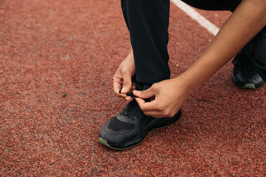 Unrecognizable person tying his shoelaces.