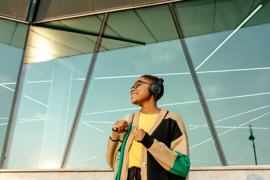 Smiling young woman listening to music