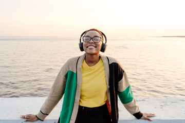 Woman enjoying music in city embankment