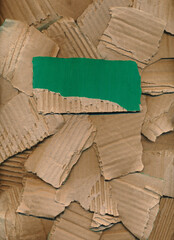 Cover, poster from pieces of torn cardboard. Place for title, description. Green brown carton background, banner. Recycling concept. Rough pieces of ripped corrugated ribbed cardboard. Design element