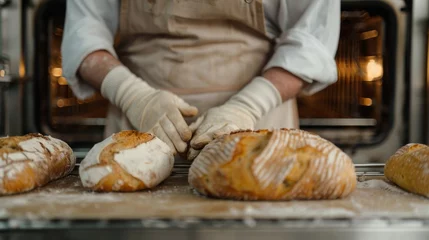 Photo sur Plexiglas Boulangerie baker in a beige apron holds fresh bread, bakery