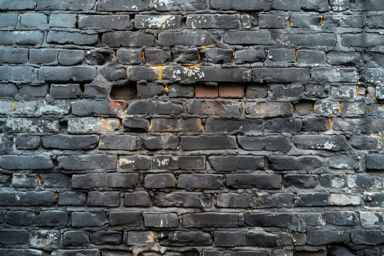 A brick wall with a hole in the center, showing the inner structure behind the missing brick © koala studio