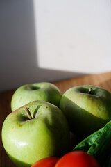 green juicy firm apples closeup on a wooden board