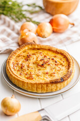 Traditional french pie. Quiche lorraine on white table.