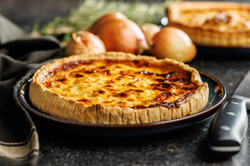 Traditional french pie. Quiche lorraine on kitchen table.
