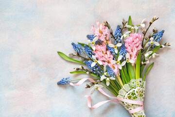 Bouquet of spring flowers of hyacinths, muscari, snowdrops and willow branches on a decorative colorful background. Postcard for Women's Day March 8, birthday - 751322131