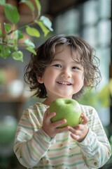 Fototapeta premium Happy Asian child holding green apple in hands