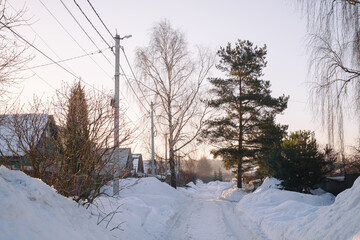 village street with large snowdrifts in winter