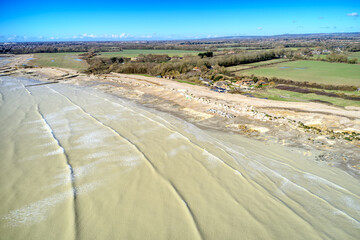 Atherington and Climping beach in West Sussex and the damaged sea defence and the temporary shingle bank in place to protect the land, aerial view.