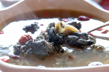 Chinese black chicken soup. Chinese traditional nourishing health stew very famous among chinese food and asian food as a healthy soup, food as medicine.