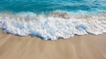 Beautiful Soft blue ocean wave crashing on fine sandy beach