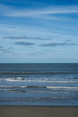 view of waves on the beach on blue sky background - 751337116