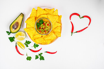 Nachos. Crispy tortilla chips topped with melted cheddar cheese, salsa,pepper, jalapeno, guacamole, lime and garlic. Classic traditional Tex-Mex or Mexican restaurant menu item. Chili pepper heart