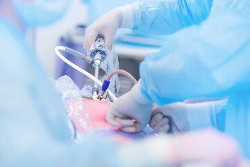 Closeup surgeon hold surgical equipment in minimal invasive endoscopic surgery, blue light. Team...