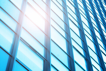 Office building texture. Glass skyscraper background. Glass window building. Sunny day architecture. Window sunlight reflection. Bright warm sunbeam on cold glass.