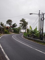 Fototapeta na wymiar Bali Island 22 May 2023: car on the road when cloudy