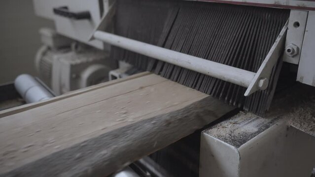 machine for cutting wood plank at factory workshop