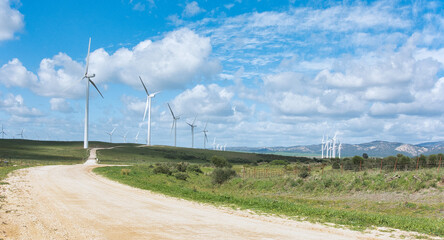 Sustainable energy concept with windmills on a cloudy day environmentally friendly power generation - 751356598