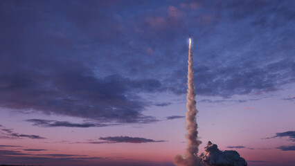 Space rocket with smoke and blast will successfully take off into the pink evening sky with clouds....