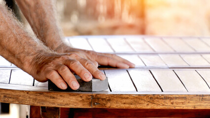 Craftsman Skillfully Sanding Wooden Surface